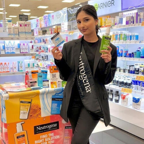 9 Yard Marketing in-store activation with a promoter assisting shoppers.